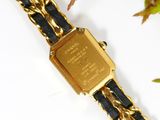 an image of a close up of a wrist watch with a chain around it