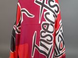 a close up of a red and black scarf on a mannequin