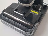 an image of a black and white coffee maker sitting on top of a table