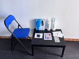 une chaise bleue et une table noire dans une pièce