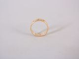 a close up of a gold ring on a white surface