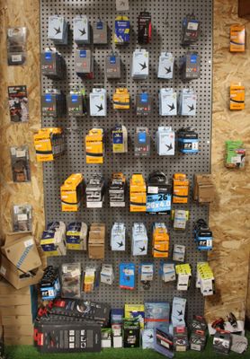 a display of cell phones on a pegboard in a store