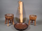 three pieces of wood are sitting on a table next to a bowl and wooden stool