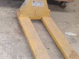 a pallet that is sitting on the ground next to a fork