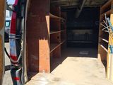 the back of a van with a surfboard in the back of it