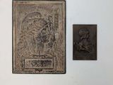une photo d'une plaque accrochée au mur, à côté d'une autre plaque sur laquelle figure la photo d'un homme