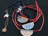 several necklaces and bracelets are laid out on a black surface