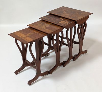 three wooden nesting tables with intricate designs on them