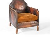 une photo d'un fauteuil en cuir marron avec un coussin marron