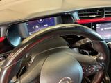 a steering wheel and dashboard of a car in a car showroom