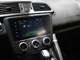 the interior of a car with a steering control and dashboard controls