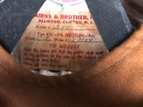 a label on the back of a brown jacket