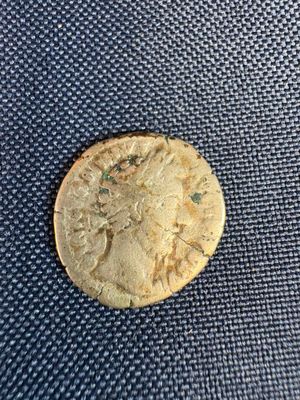 a close up of a gold coin on a blue cloth