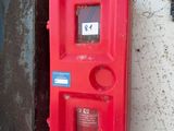a red fire hydrant on the side of a building