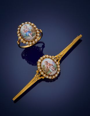 two gold - plated hair pins with a picture of a man and woman on them