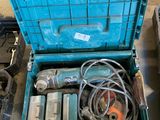 a blue tool box with tools in it on the floor