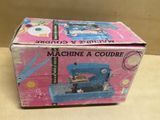 a box that has a sewing machine inside of it