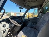 the interior of a white truck with a gray seat and steering wheel