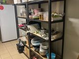 a shelf with dishes and bowls on it in a kitchen