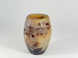 a small vase with a design on it on a white surface