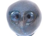 an image of a blue owl figurine on a white background