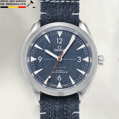 an image of a close up of a wrist watch with a blue strap