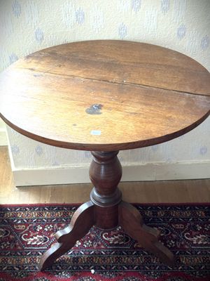 une petite table en bois avec un plateau en bois, posée sur un tapis