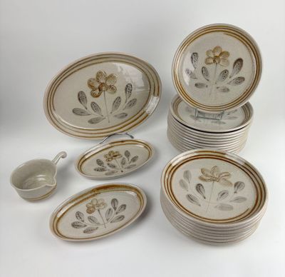 a lot of plates and bowls that are sitting on a table
