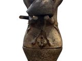 a statue of a cat sitting on top of a vase