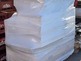 a large stack of white paper sitting on a pallet