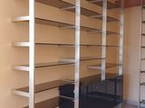 a room with a shelf and a chair in it