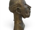 bronze sculpture of a man ' s head on a white background