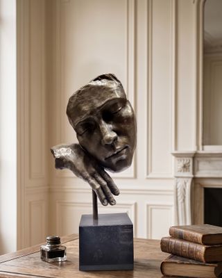 a sculpture of a woman ' s head on a table
