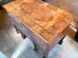 a wooden table with carvings on it in a room