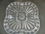 a clear glass plate with a flower design on it