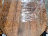 a wooden table that has been wrapped in plastic