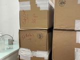 many boxes stacked on top of each other in a room