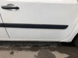 a small white car parked on the side of the road