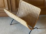 a wicker chair in the corner of a room