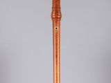 an image of a wooden flute on a clear surface