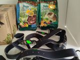 two bags of cat food and a pair of leashes on the counter