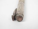 a wooden stick that is laying on a white surface