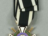 a close up of a medal with a cross on it