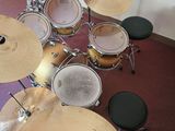a drum set up in the corner of a room