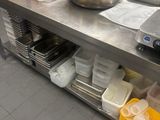 a large kitchen with a lot of pots and pans on the counter