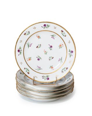 four plates with floral designs are stacked on top of each other