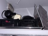 a laptop computer sitting on top of a shelf in a room