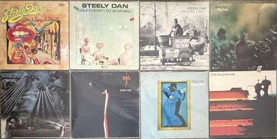 various album covers of various albums on a wall in a room