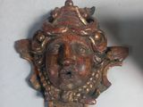 a statue of a man ' s face on the wall