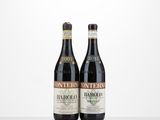 two bottles of wine sit side by side on a table